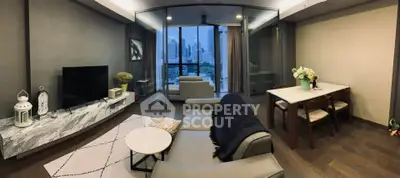 Modern living room with city view, stylish decor, and elegant furniture.