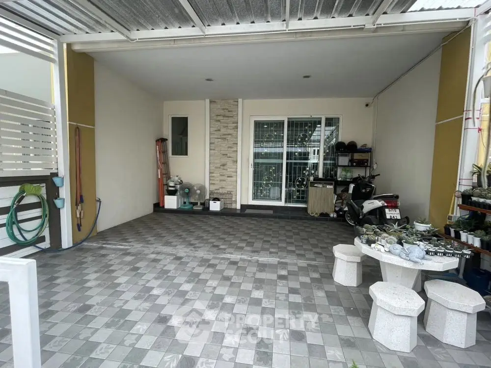 Spacious covered parking area with tiled flooring and garden view