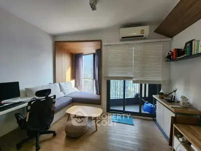 Modern living room with cozy seating and large window view