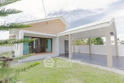 Charming modern house with spacious carport and lush green lawn, perfect for family living.