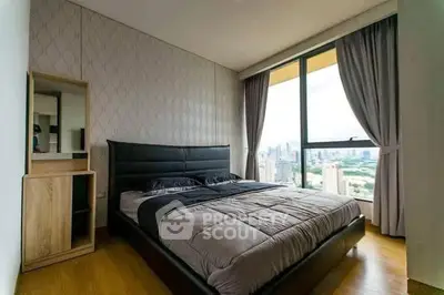 Modern bedroom with large window offering stunning city view, featuring elegant decor and cozy bedding.