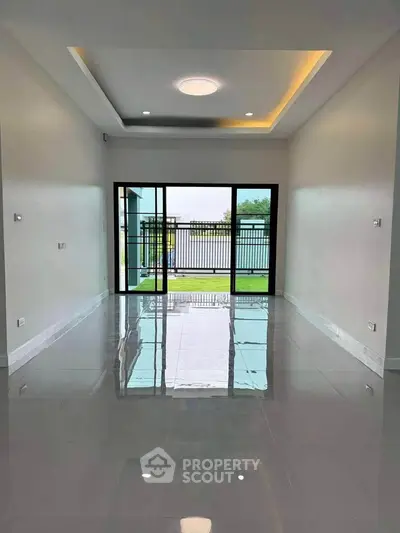 Spacious modern living room with large glass doors and polished floors