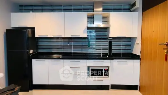 Modern kitchen with sleek cabinetry and built-in appliances