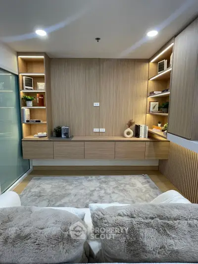 Modern living room with built-in wooden shelves and cozy seating area