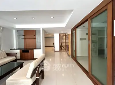 Spacious living room with modern design and elegant glass doors