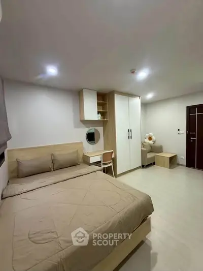 Modern bedroom with cozy bed, built-in wardrobe, and stylish decor