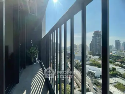 Stunning city view from modern high-rise balcony with sleek railing design.