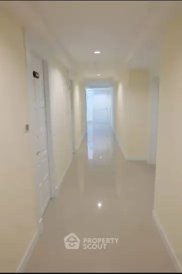 Bright and spacious corridor with glossy floors in modern building