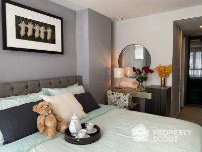 Cozy bedroom with elegant decor and plush bedding, featuring a stylish vanity and decorative accents.