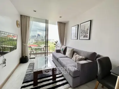 Modern living room with city view, stylish decor, and comfortable seating in a high-rise apartment.