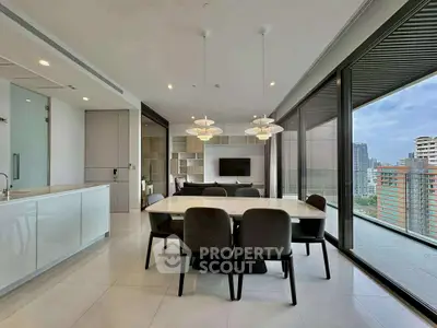 Modern open-plan living room with city view and sleek dining area.