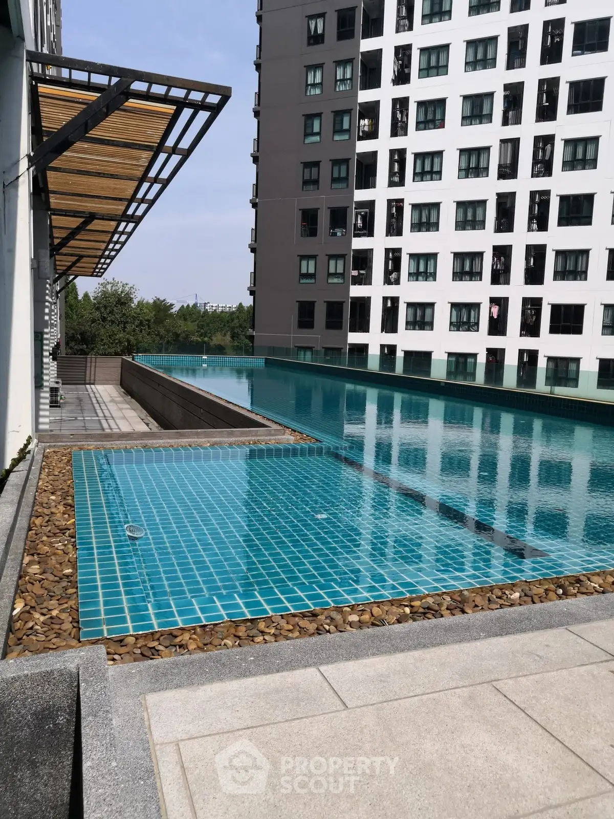 Modern apartment building with luxurious rooftop pool and scenic view.