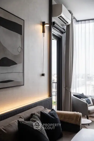 Modern living room with stylish decor and large window offering city views.