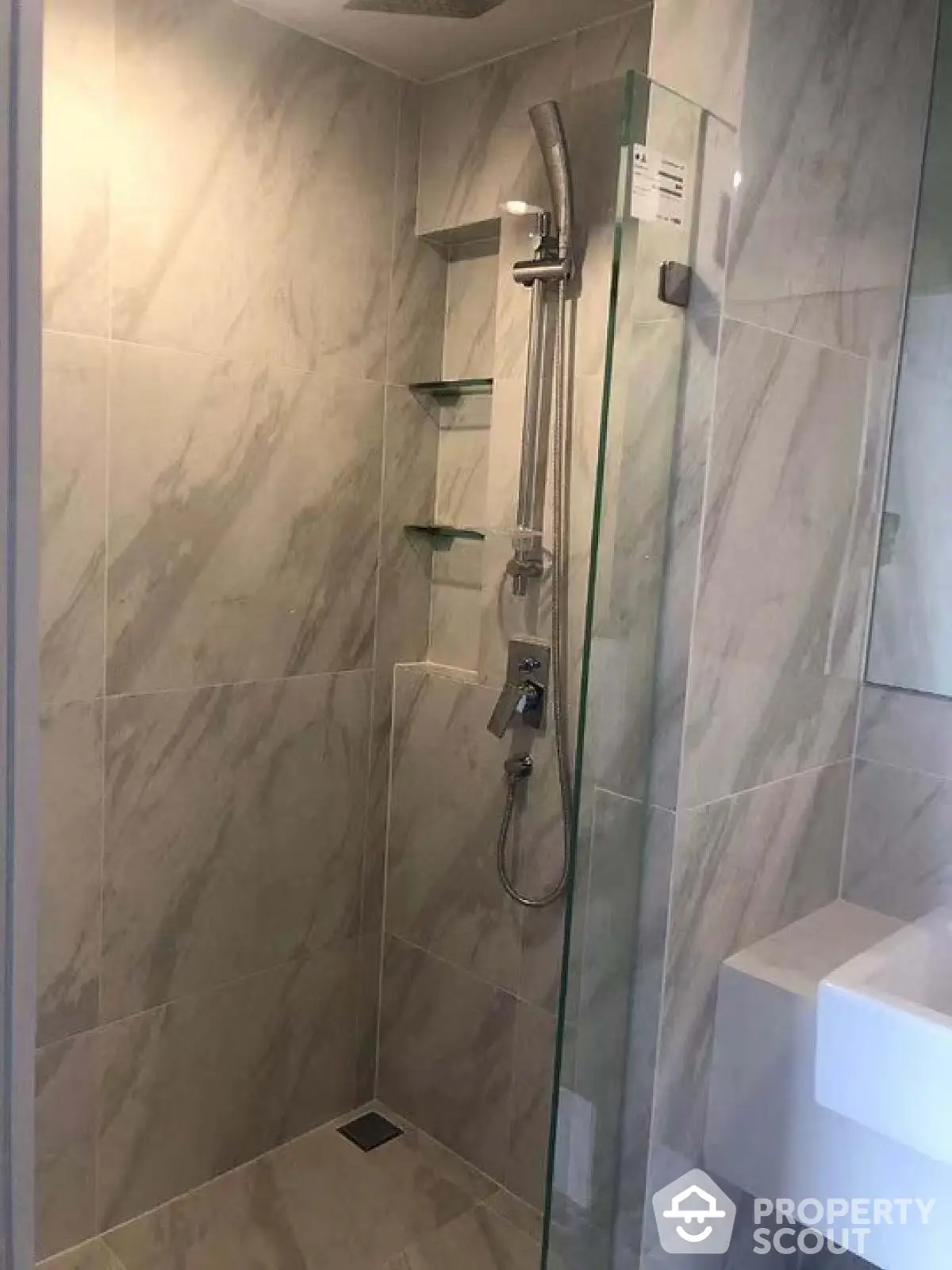 Modern bathroom with sleek shower and marble tiles