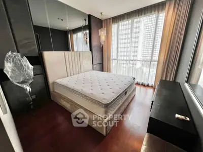 Modern bedroom with large window and elegant decor in high-rise apartment