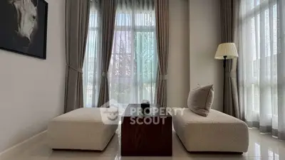 Elegant living room with modern furniture and large windows for natural light.