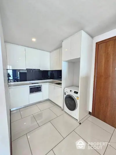 Modern kitchen with sleek white cabinets and built-in appliances