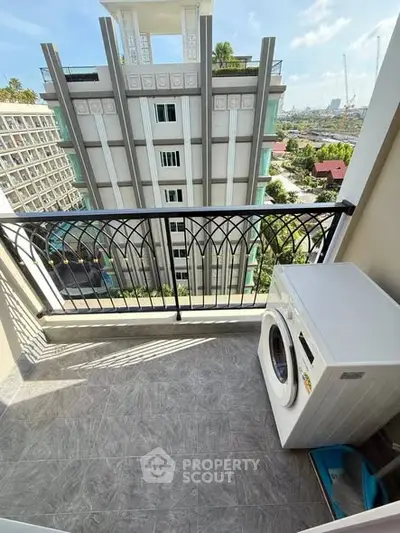 Charming balcony with washing machine and city view in modern apartment building.
