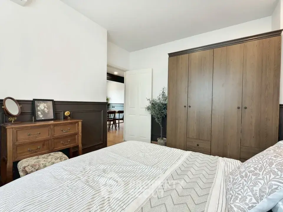 Charming bedroom with elegant wooden furniture and cozy decor