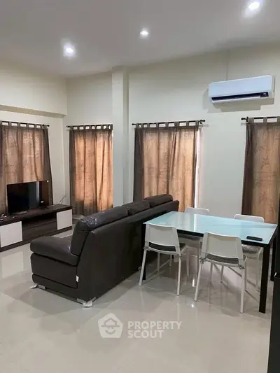 Modern living room with sleek furniture and natural light, perfect for relaxation and entertainment.
