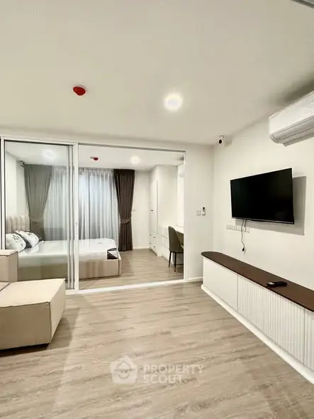 Modern living room with sleek design and bedroom view