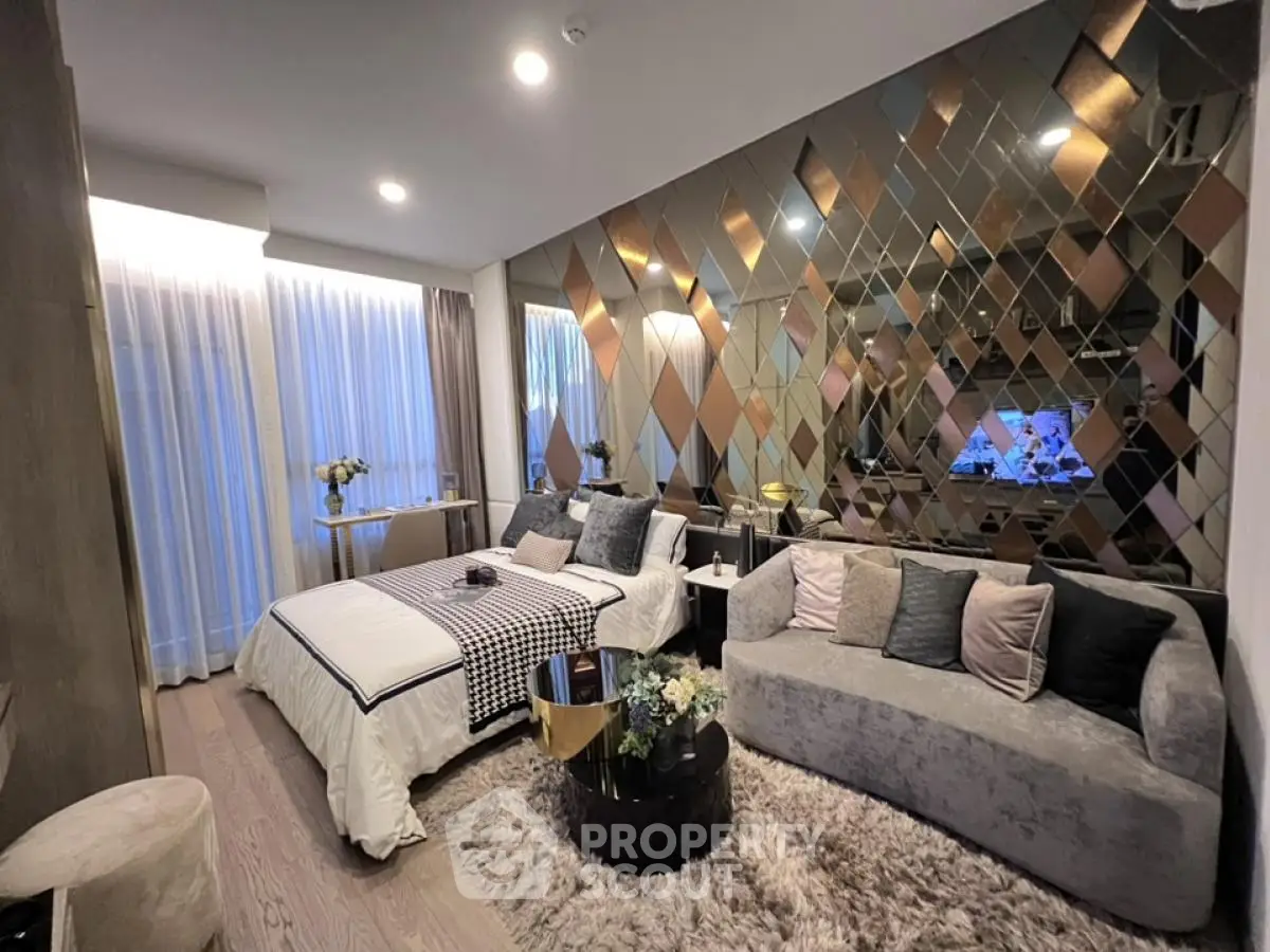 Luxurious bedroom with elegant decor and mirrored accent wall