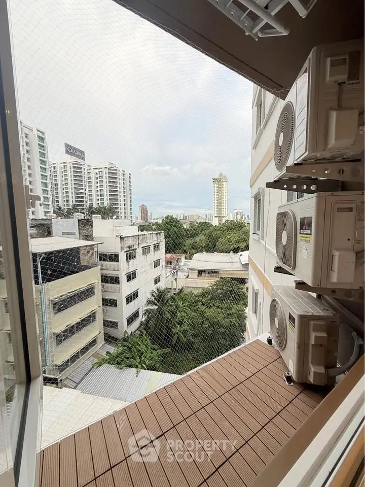 High-rise building view with air conditioning units and cityscape background.