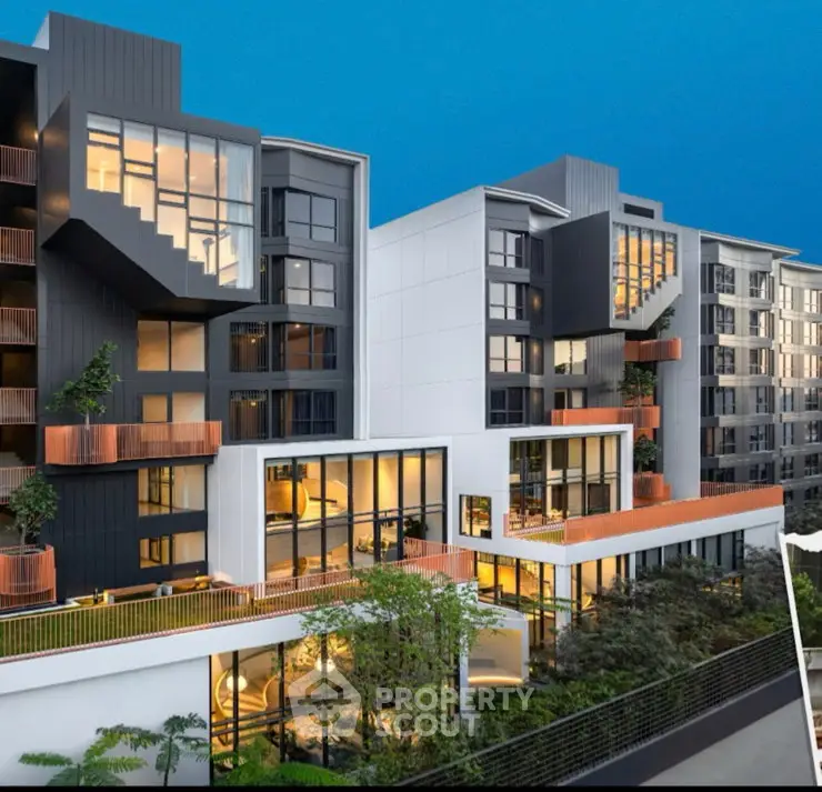 Modern architectural building with large windows and lush greenery, showcasing contemporary urban living.
