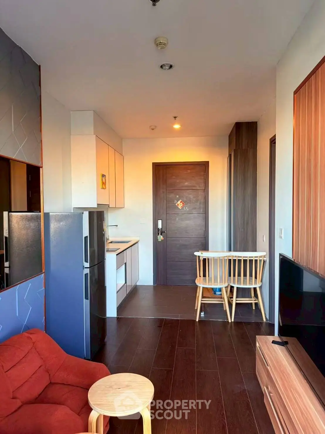 Modern apartment interior with cozy living area and compact kitchen