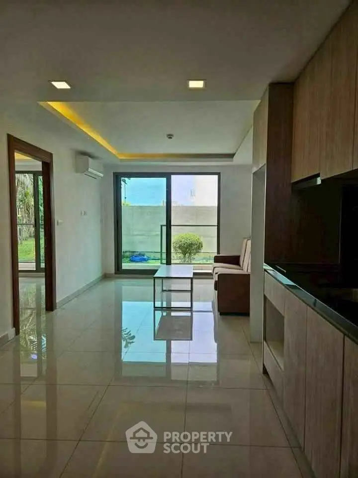 Modern living room with garden view and sleek kitchen design