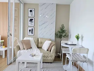 Chic modern living room with cozy beige sofa, stylish decor, and dining area, perfect for urban living.
