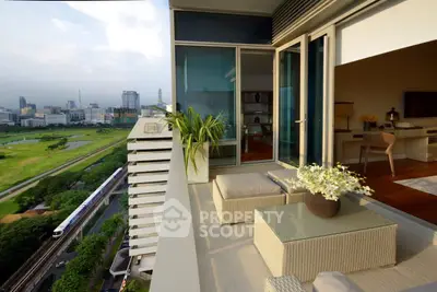 Luxurious high-rise balcony with stunning city view and modern outdoor furniture.