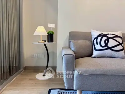 Modern living room with stylish gray sofa and elegant side table, perfect for cozy relaxation.