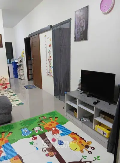 Charming family living room with playful decor and modern entertainment setup.