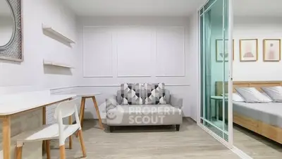 Modern living room with stylish decor and adjacent bedroom view