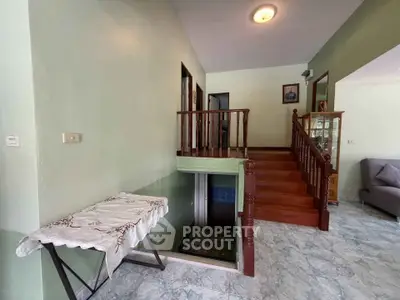 Charming interior with wooden staircase and cozy living area, perfect for family gatherings.