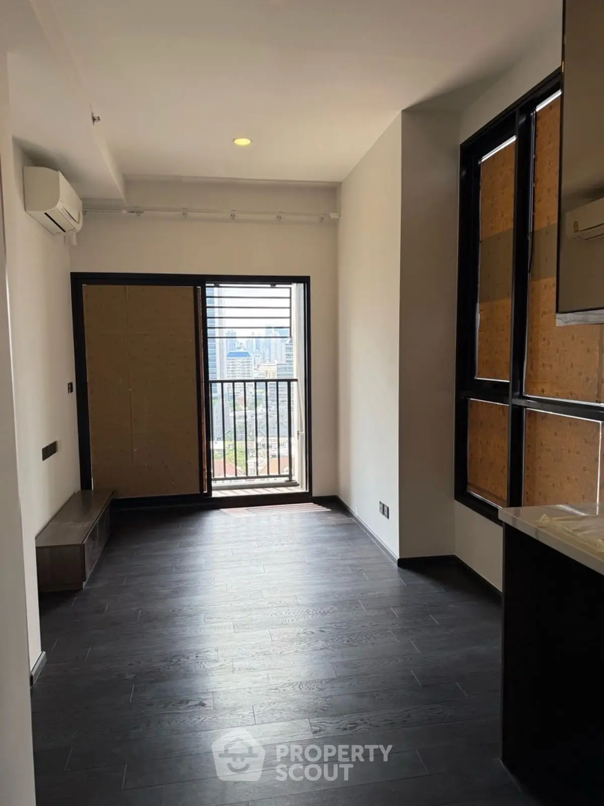 Modern apartment with dark wood flooring and balcony view