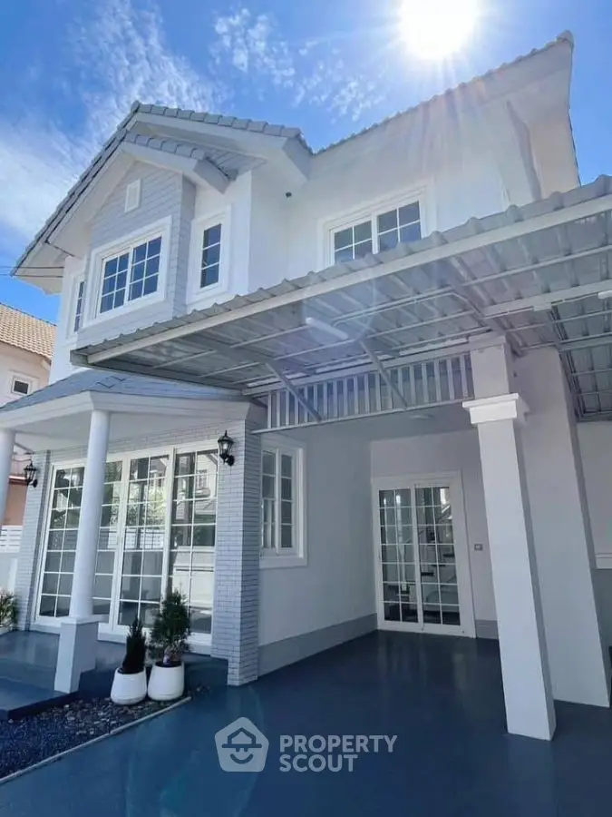 Stunning modern two-story house with elegant facade and spacious driveway.