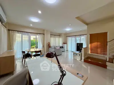 Spacious living room with modern decor and ample natural light