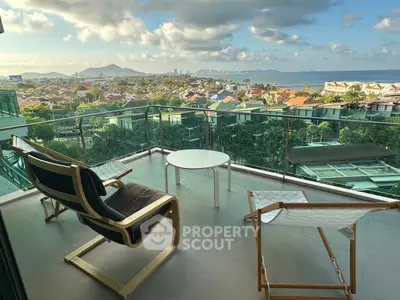 Stunning balcony with panoramic ocean view and modern seating