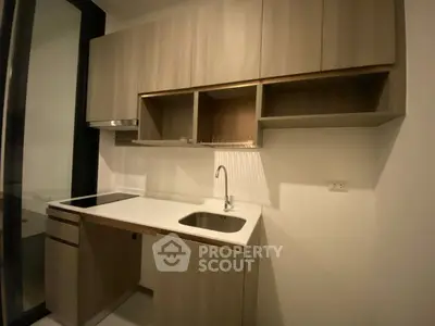 Modern compact kitchen with sleek cabinets and built-in sink