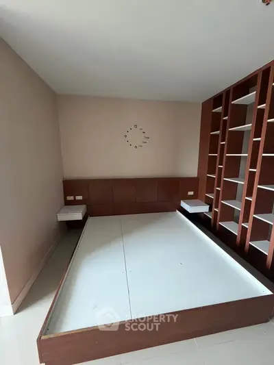 Spacious bedroom with built-in shelves and modern minimalist design