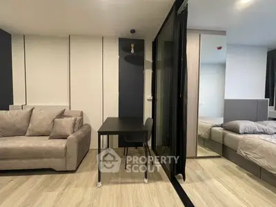 Modern studio apartment with stylish decor, featuring a cozy living area and a comfortable bedroom.