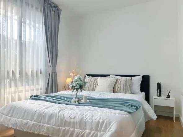 Elegant bedroom with cozy bedding and natural light