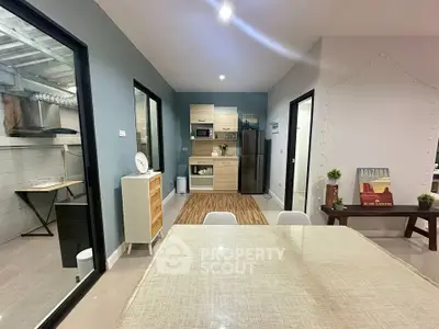 Modern kitchen with open layout and stylish decor, featuring sleek appliances and a cozy dining area.