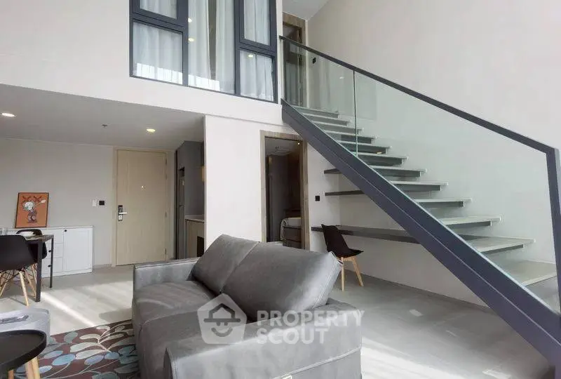 Modern duplex living room with sleek staircase and stylish decor