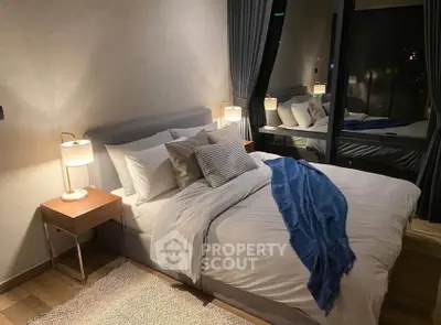 Cozy modern bedroom with stylish decor and large window view.