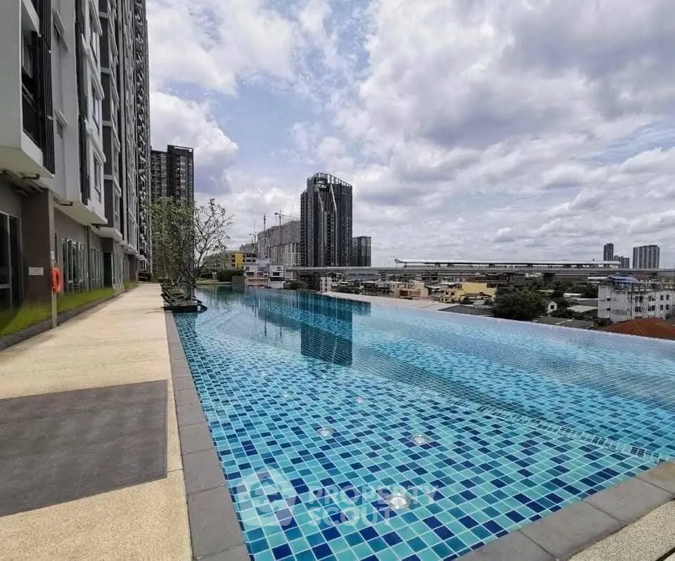 Luxurious high-rise building with stunning infinity pool and cityscape view.