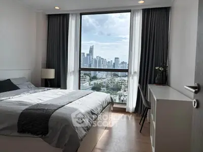 Modern bedroom with city view, featuring sleek furniture and large window for natural light.