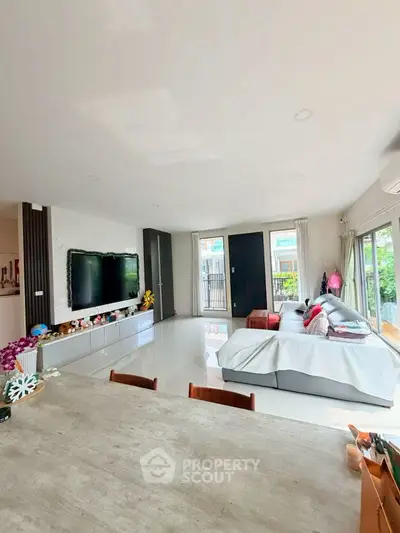 Spacious modern living room with large windows and stylish decor